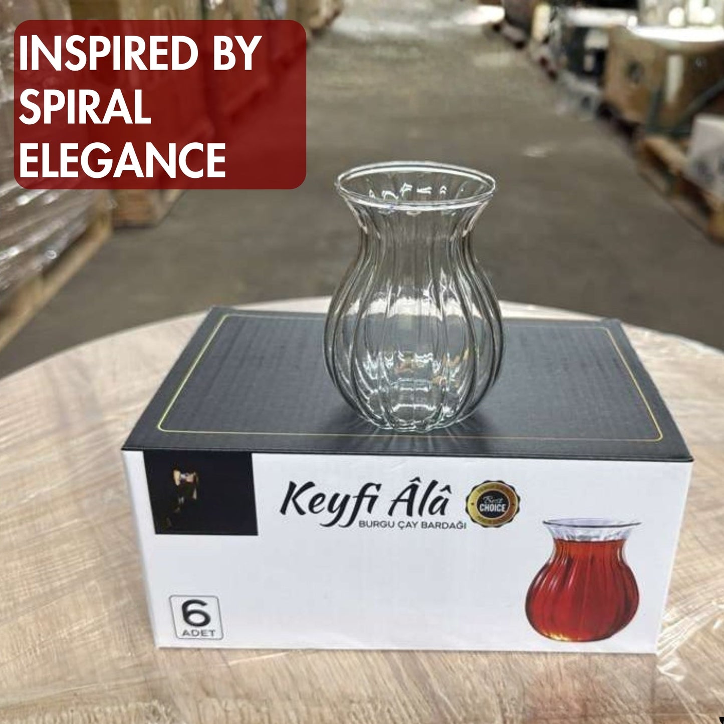 Clear glass vase on a box labeled 'Keyfi Ala' with warehouse background