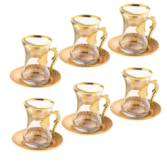Set of six gold-rimmed glass coffee cups and saucers on a white background