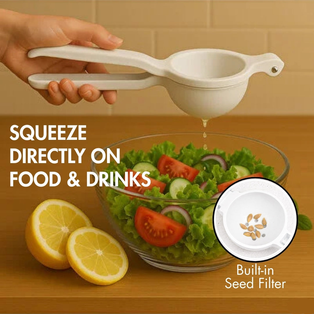 Hand holding a white lemon squeezer over a salad with lemons on a wooden surface.