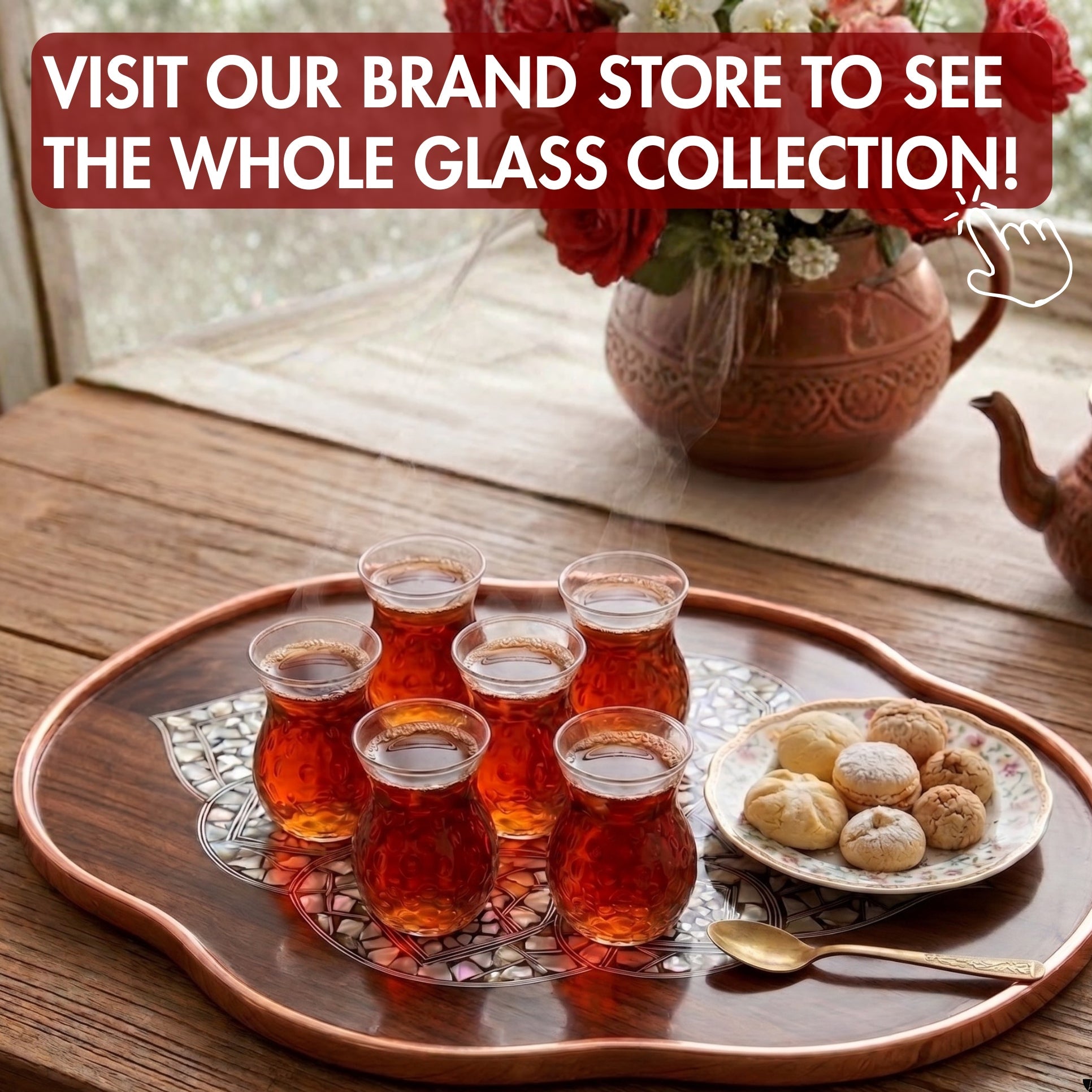 Tea glasses on a tray with cookies and a teapot, promoting a brand store.