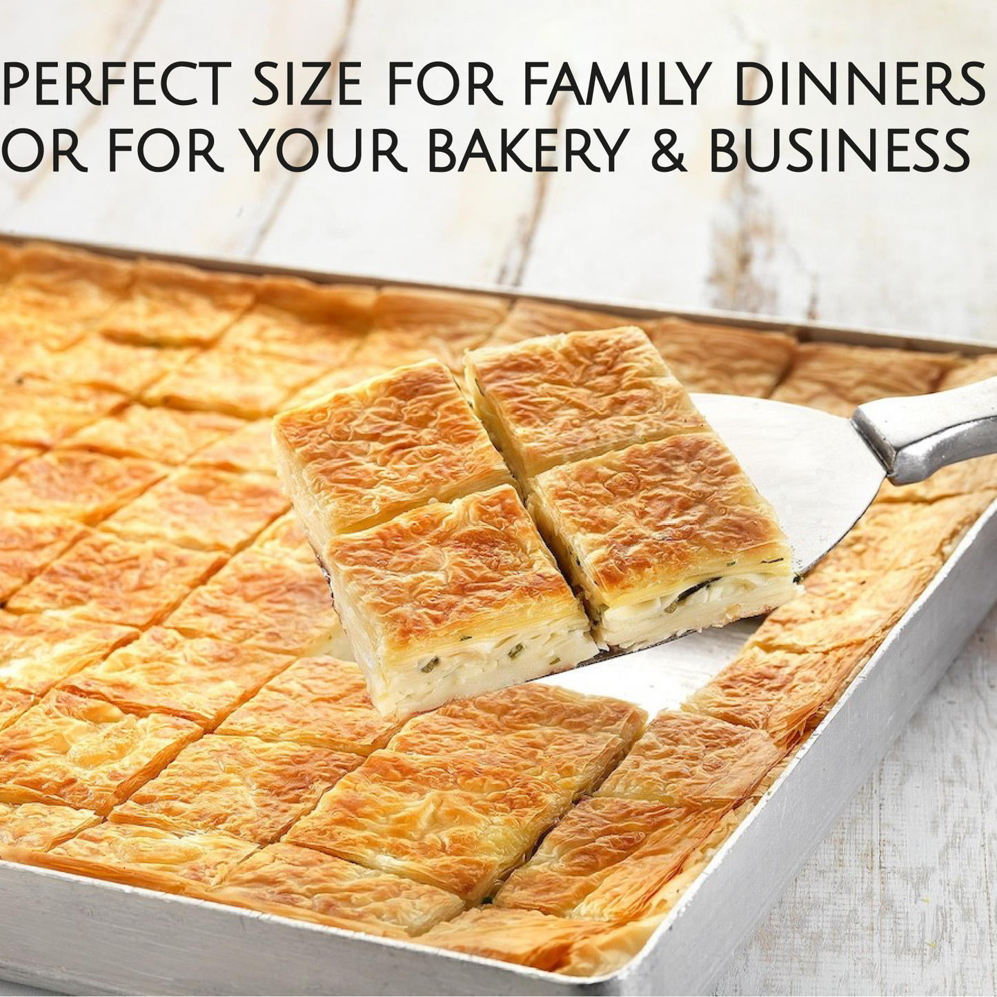 Baked dish cut into squares with a spatula, placed on a baking tray, with text about size for family dinners or bakery business.
